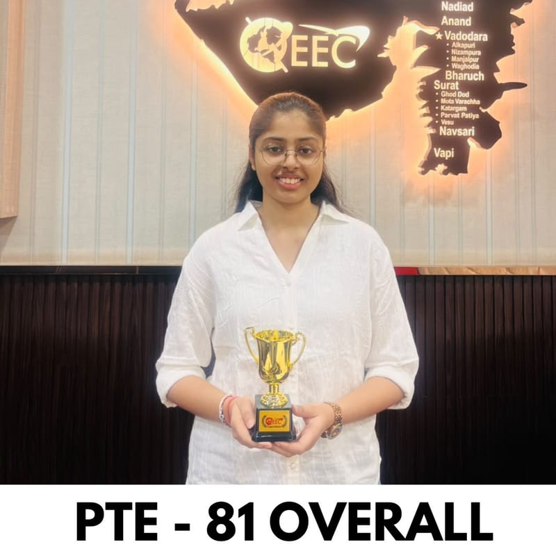 EEC student holding their trophy in front of the EEC Gujarat branch map after scoring PTE 81 overall